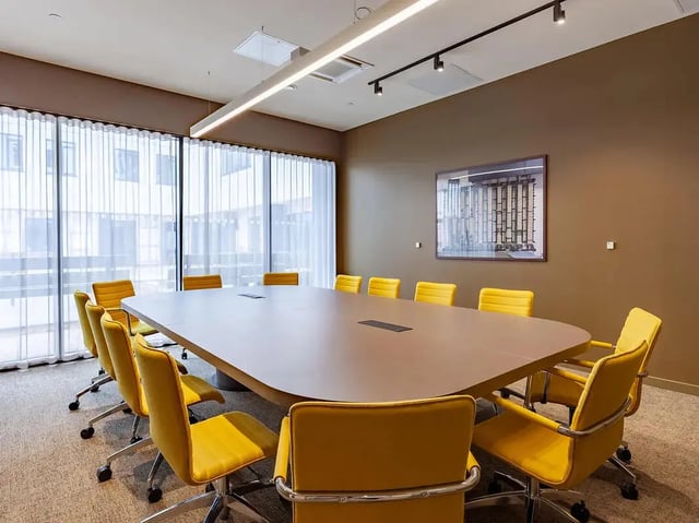 Conference table with yellow chairs meeting room at Yugo St. Crispin's House in Norwich Student Accommodation