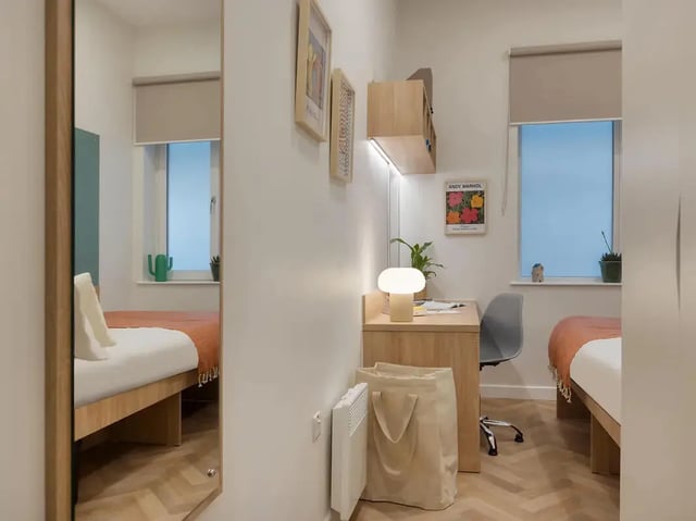 Two beds desk lamp and bag bedroom at Yugo St. Crispin's House in Norwich Student Accommodation