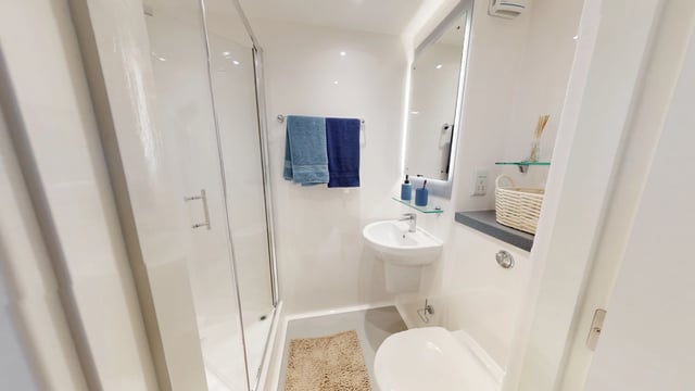 Shower sink toilet towels and mirror bathroom at Enso in Colchester Student Accommodation