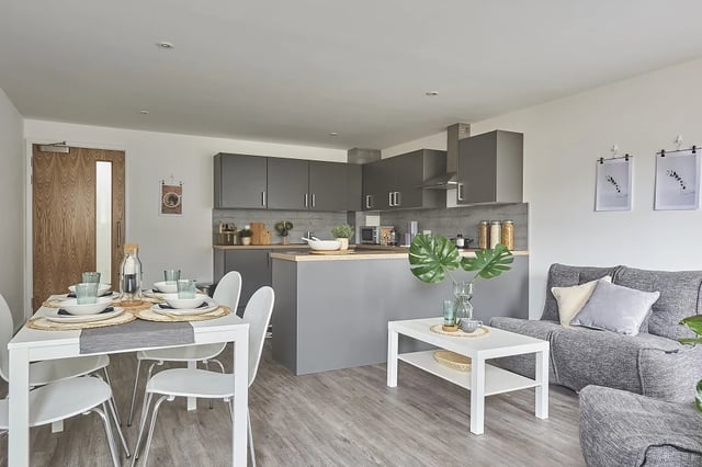 Table chairs kitchen sofa and coffee table living area at The City Arcade - Exeter in Exeter Student Accommodation
