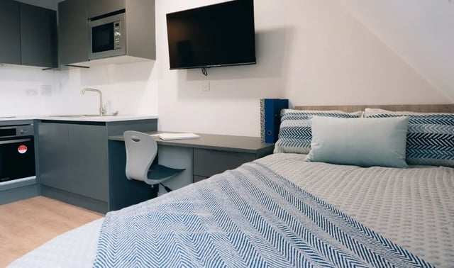 Bed desk kitchen area and TV bedroom at Boutique Student Living - Exeter in Exeter Student Accommodation
