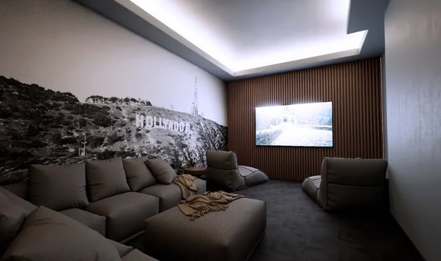 Gray sectional sofa beanbags screen Hollywood mural living room at Boutique Student Living - Exeter in Exeter Student Accommodation