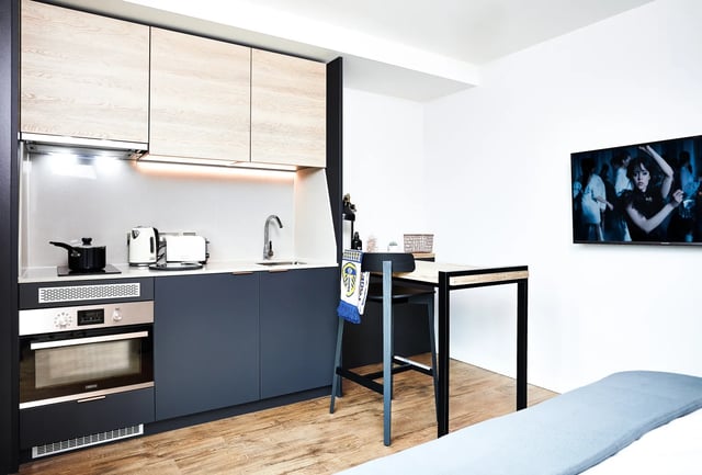 Modern kitchen with oven sink and TV Living room at Vita Student St.Albans in Leeds Student Accommodation