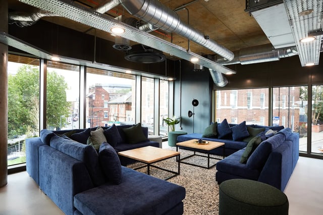 Blue sofas coffee tables plant lamp living room at Vita Student St.Albans in Leeds Student Accommodation