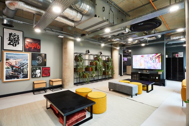 Modern lounge with sofas tv and plants common area at Vita Student St.Albans in Leeds Student Accommodation