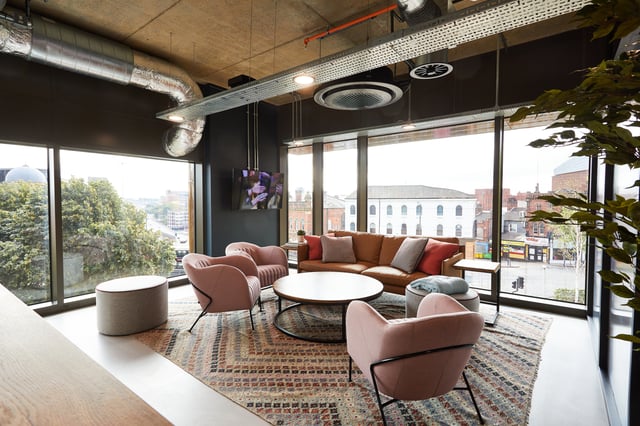 Pink chairs brown sofa rug coffee table living room at Vita Student St.Albans in Leeds Student Accommodation