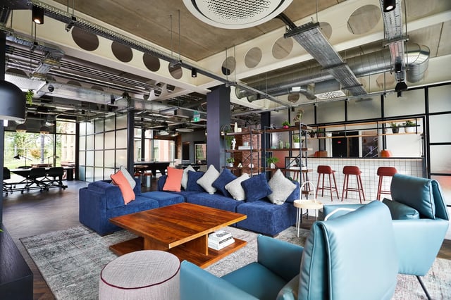Blue sectional couch and chairs communal area at Vita Student Pebble Mill in Birmingham Student Accommodation