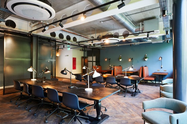 Large wooden table with chairs and lamps study area at Vita Student Pebble Mill in Birmingham Student Accommodation