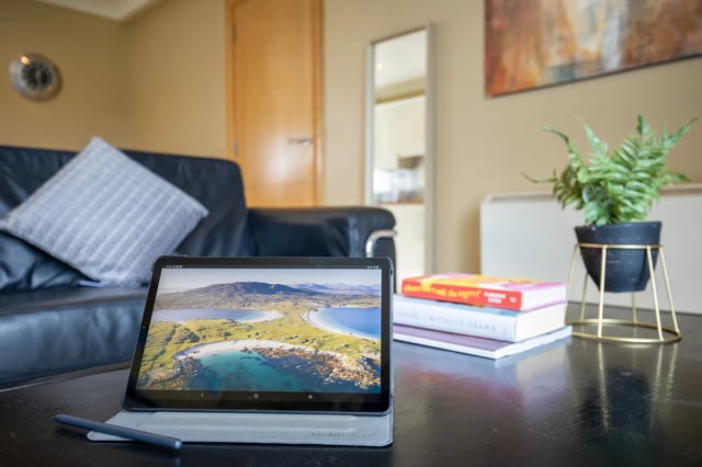 Tablet books plant leather sofa living room at Cuirt na Coiribe in Galway Student Accommodation