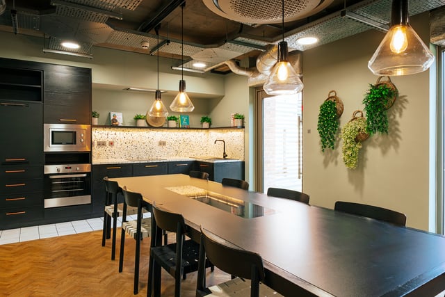 Modern kitchen island and dining table with chairs Communal area at Vita Student Station Street in Nottingham Student Accommodation