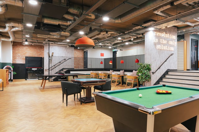 Billiard table chairs tables and stairs Common area at Vita Student Station Street in Nottingham Student Accommodation
