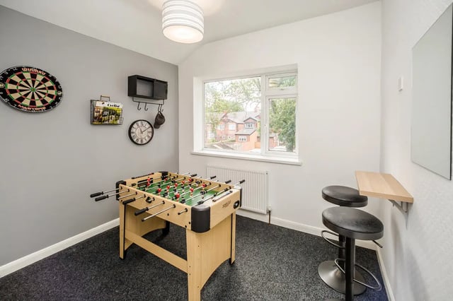 Foosball table dartboard clock and stools common room at Humber Portfolio in Hull Student Accommodation