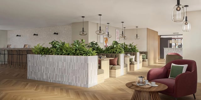 Booths, plants, and lounge chairs in a common area at Canvas Capital House in Southampton Student Accommodation
