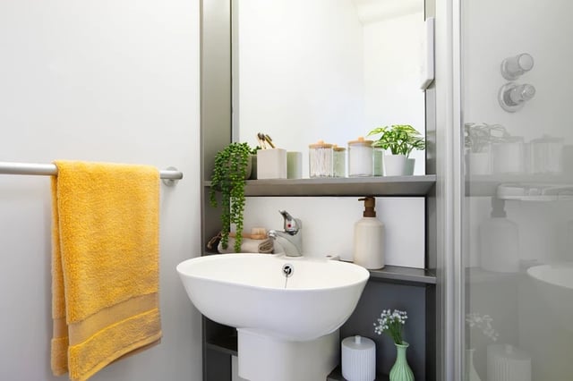Yellow towel sink soap dispenser bathroom at Charlton Court in Bath Student Accommodation