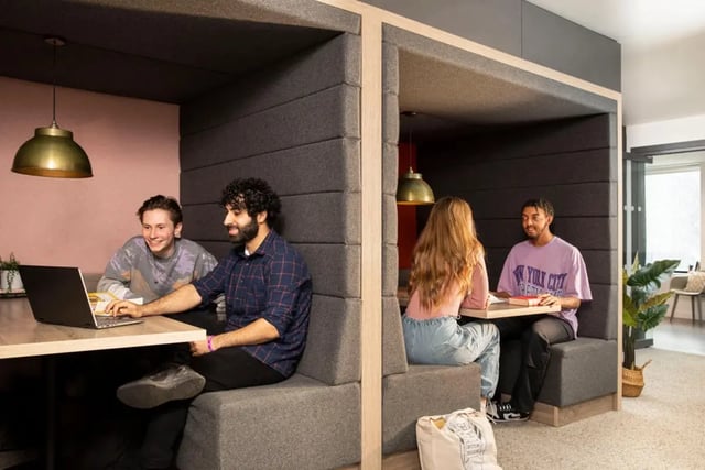 Students studying in booths with laptops and books study area at Westhill Hall in Sheffield Student Accommodation