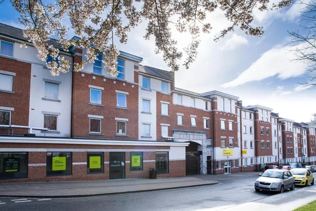 Red brick student accommodation with cars exterior at Westhill Hall in Sheffield Student Accommodation
