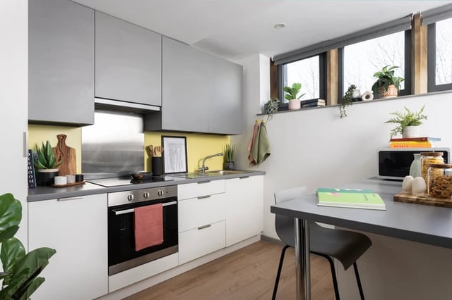 Modern kitchen with oven, sink, microwave, and table. Kitchen. at St Vincents Place in Sheffield Student Accommodation