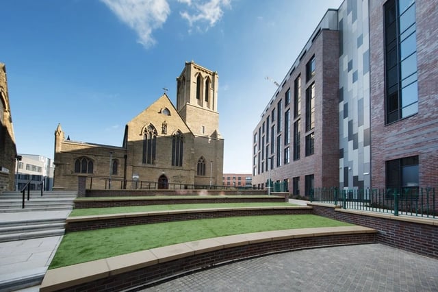 Modern building beside church with tiered grass exterior at St Vincents Place in Sheffield Student Accommodation