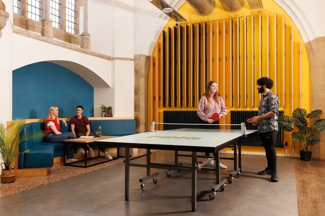 Ping pong table with people playing living room at St Vincents Place in Sheffield Student Accommodation