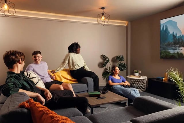 Students relaxing on sofa watching television living room at Quay Point Studios in Newcastle Upon Tyne Student Accommodation