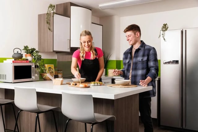 Two students eating sushi at kitchen island kitchen at Quay Point Studios in Newcastle Upon Tyne Student Accommodation