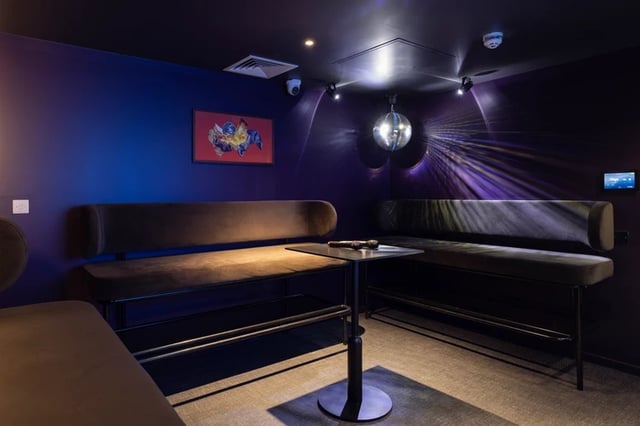 Karaoke area with couches disco ball and microphone living room at Stratford One in London Student Accommodation