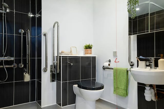 Shower toilet sink grab bars and toiletries bathroom at Campbell House in Bristol Student Accommodation