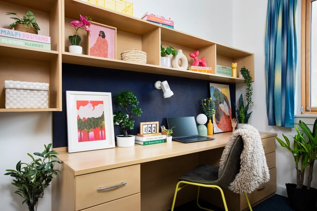 Desk with laptop plants and chair study area at Pier Quays in Medway Student Accommodation