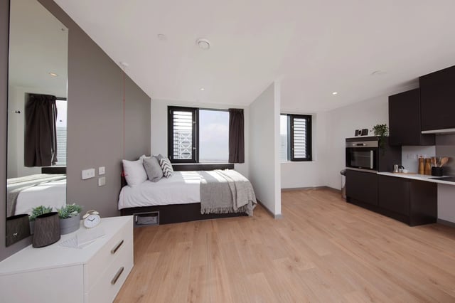 Bed kitchen microwave and cabinets studio apartment at White Rose View in Leeds Student Accommodation