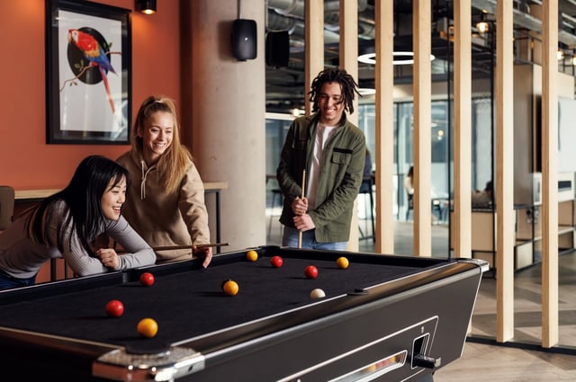 Students playing billiards in common room area at White Rose View in Leeds Student Accommodation