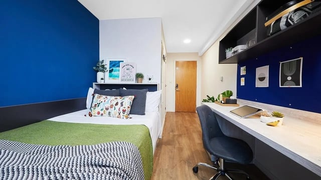 Bed with pillows desk with chair study area at Tudor Place in Chester Student Accommodation