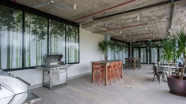 BBQ grills dining tables chairs plants communal area at UniLodge Darwin in Darwin Student Accommodation