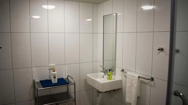 Sink mirror towel rack toiletries cart bathroom at UniLodge Darwin in Darwin Student Accommodation