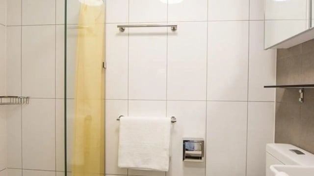 Shower glass towel rack toilet paper dispenser bathroom at UniLodge Darwin in Darwin Student Accommodation