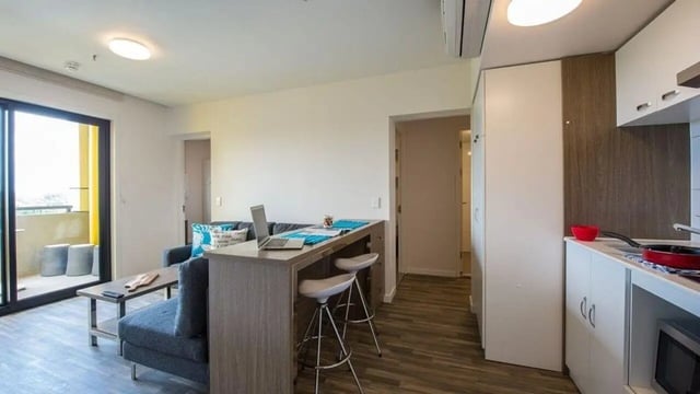 Sofa kitchen counter laptop bar stools living kitchen at UniLodge Darwin in Darwin Student Accommodation