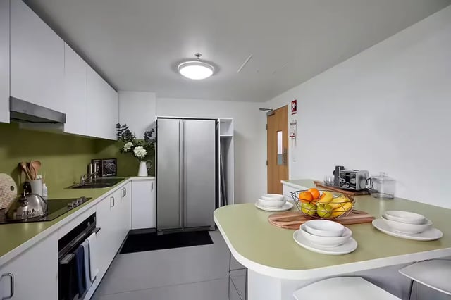 Modern kitchen with island fridge and appliances kitchen at Scape Tribune in Brisbane Student Accommodation