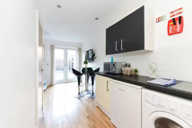 Kitchen with table chairs microwave washing machine kitchen at Brookland Road in Leicester Student Accommodation