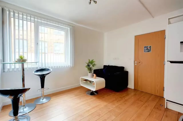 Glass table bar stools black sofa living room at Brookland Road in Leicester Student Accommodation