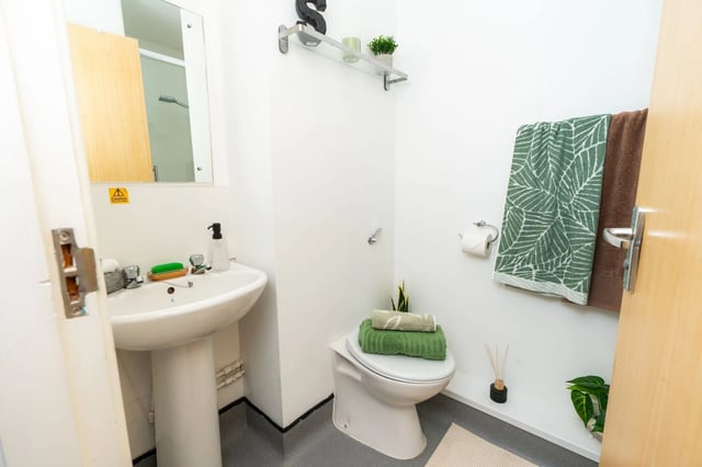 Sink toilet folded towels and shelving bathroom at Tramways - Salford in Salford Student Accommodation