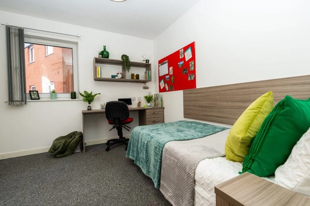 Bed desk chair shelves red noticeboard bedroom at Tramways - Salford in Salford Student Accommodation