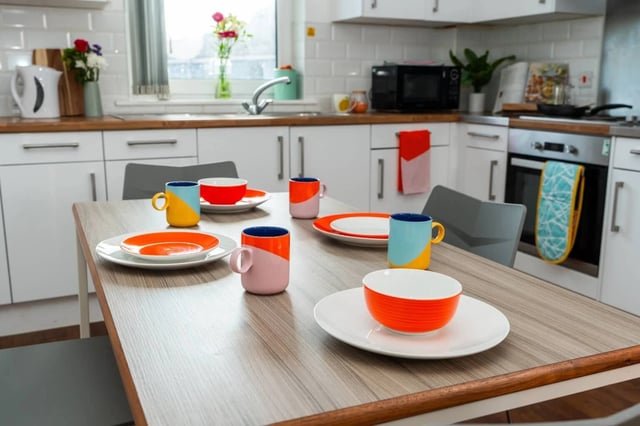 Table setting with colorful mugs plates bowls kitchen at Tramways - Salford in Salford Student Accommodation