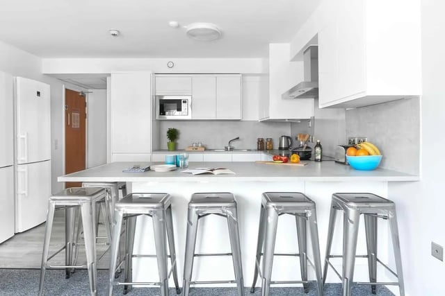 Modern kitchen with stools and fruit bowl kitchen at Bernard Myers House in London Student Accommodation