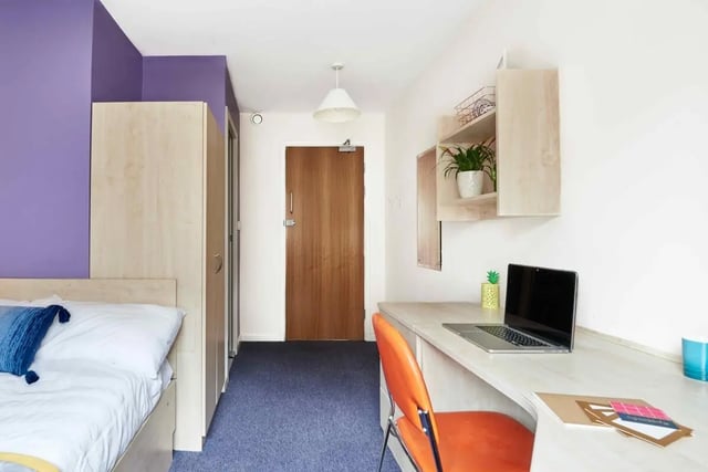 Bed wardrobe desk chair plants bedroom at Bernard Myers House in London Student Accommodation