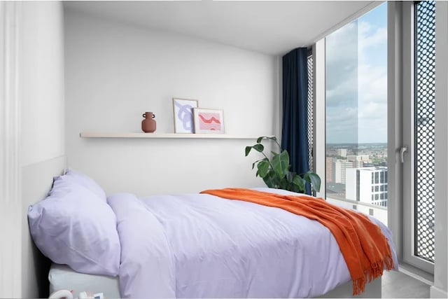 Bed with purple bedding orange throw art Bedroom at Scape Leeds in Leeds Student Accommodation