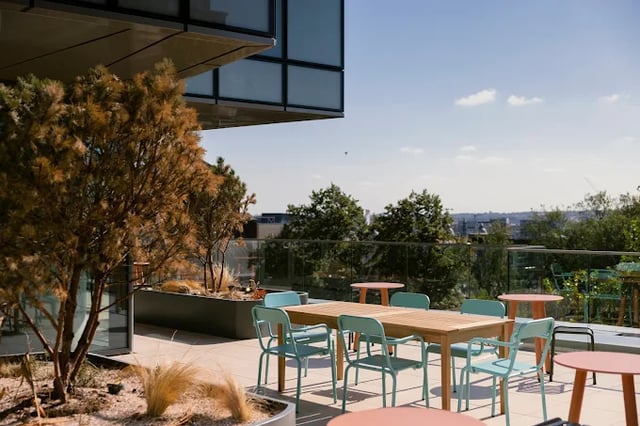 Outdoor seating area with tables and chairs terrace at Scape Leeds in Leeds Student Accommodation