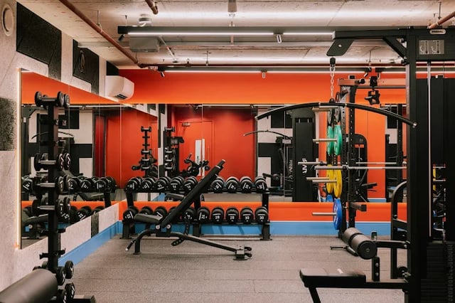 Dumbbells weights bench and gym equipment fitness room at Scape Leeds in Leeds Student Accommodation