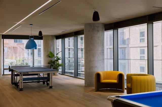 Ping pong table yellow chairs pool table lounge at Scape Leeds in Leeds Student Accommodation