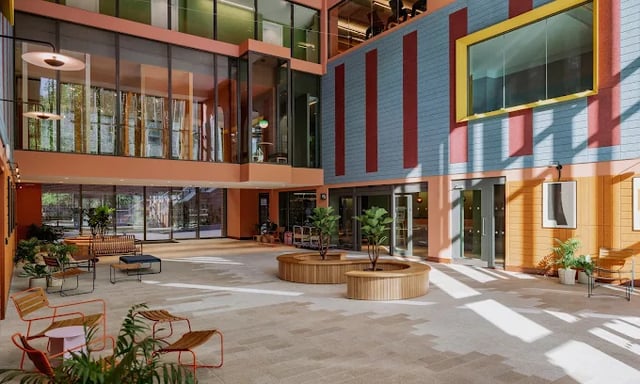 Modern communal area with benches plants and seating. at Scape Leeds in Leeds Student Accommodation