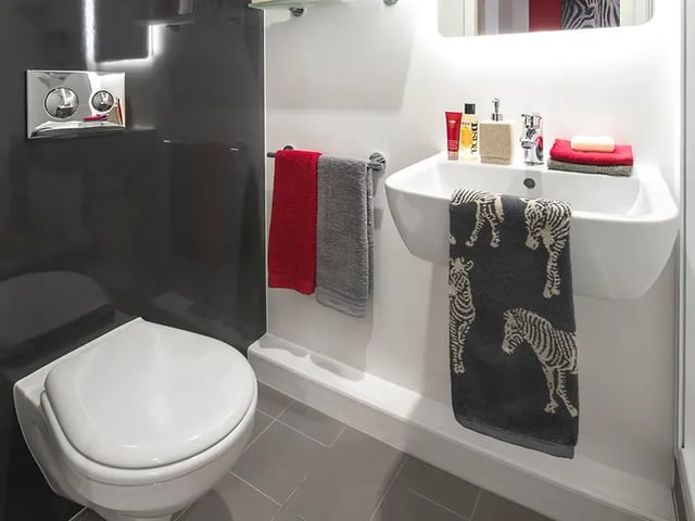 Toilet sink with towels and toiletries bathroom at Yugo Arran House in Edinburgh Student Accommodation