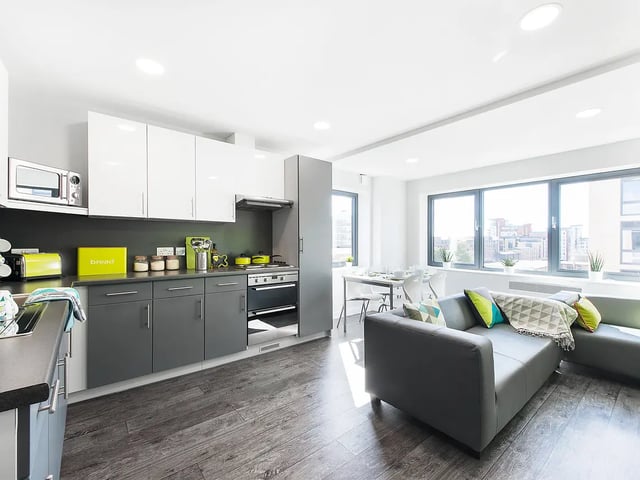 Modern kitchen and living room with sofa and windows at Yugo Austen House in Southampton Student Accommodation